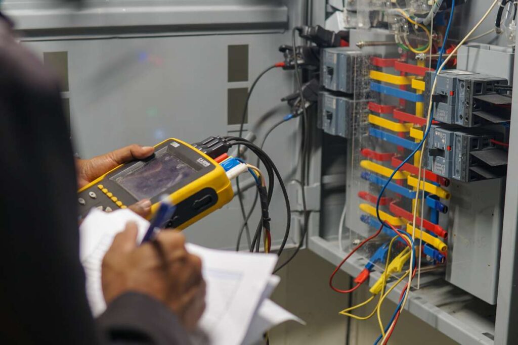 An electrician in Shawneee, KS, notes details on a service job.